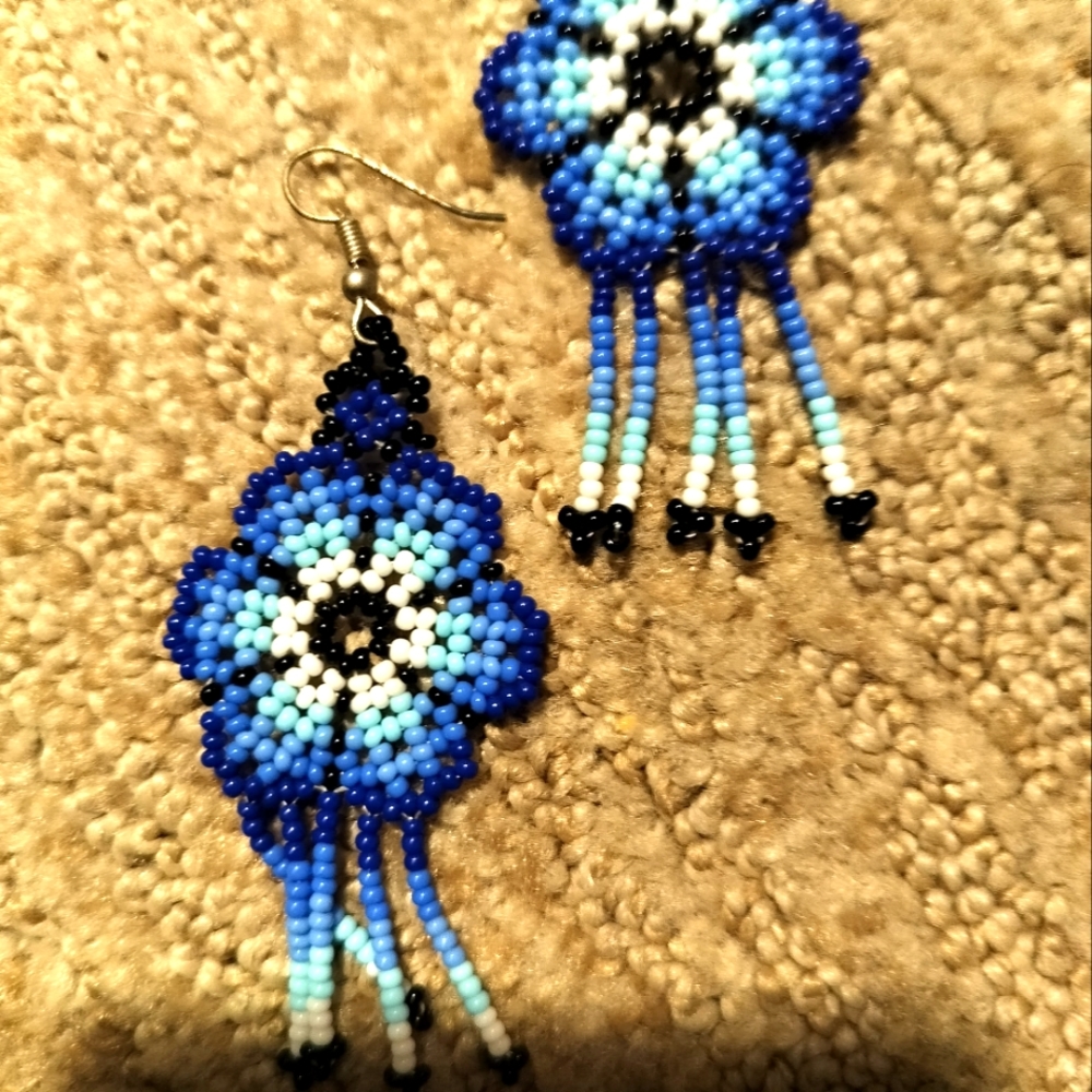 Mexican earrings self beaded by hand .